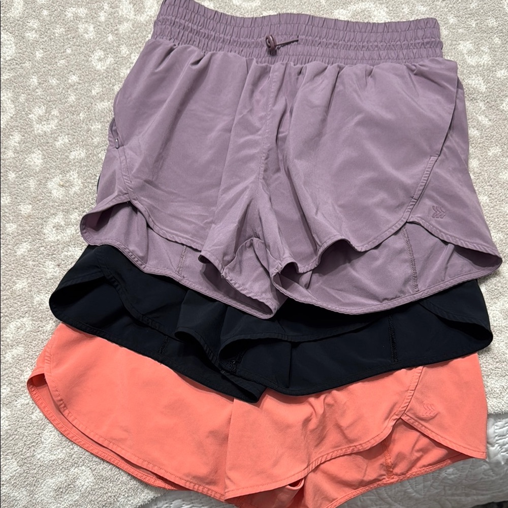 All in motion women’s High rise shorts 3-pack: mauve, black and coral.